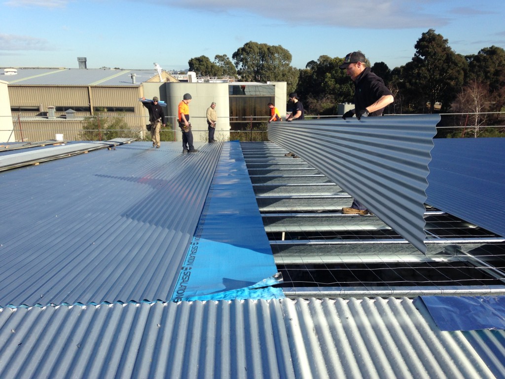 Laying roof sheeting